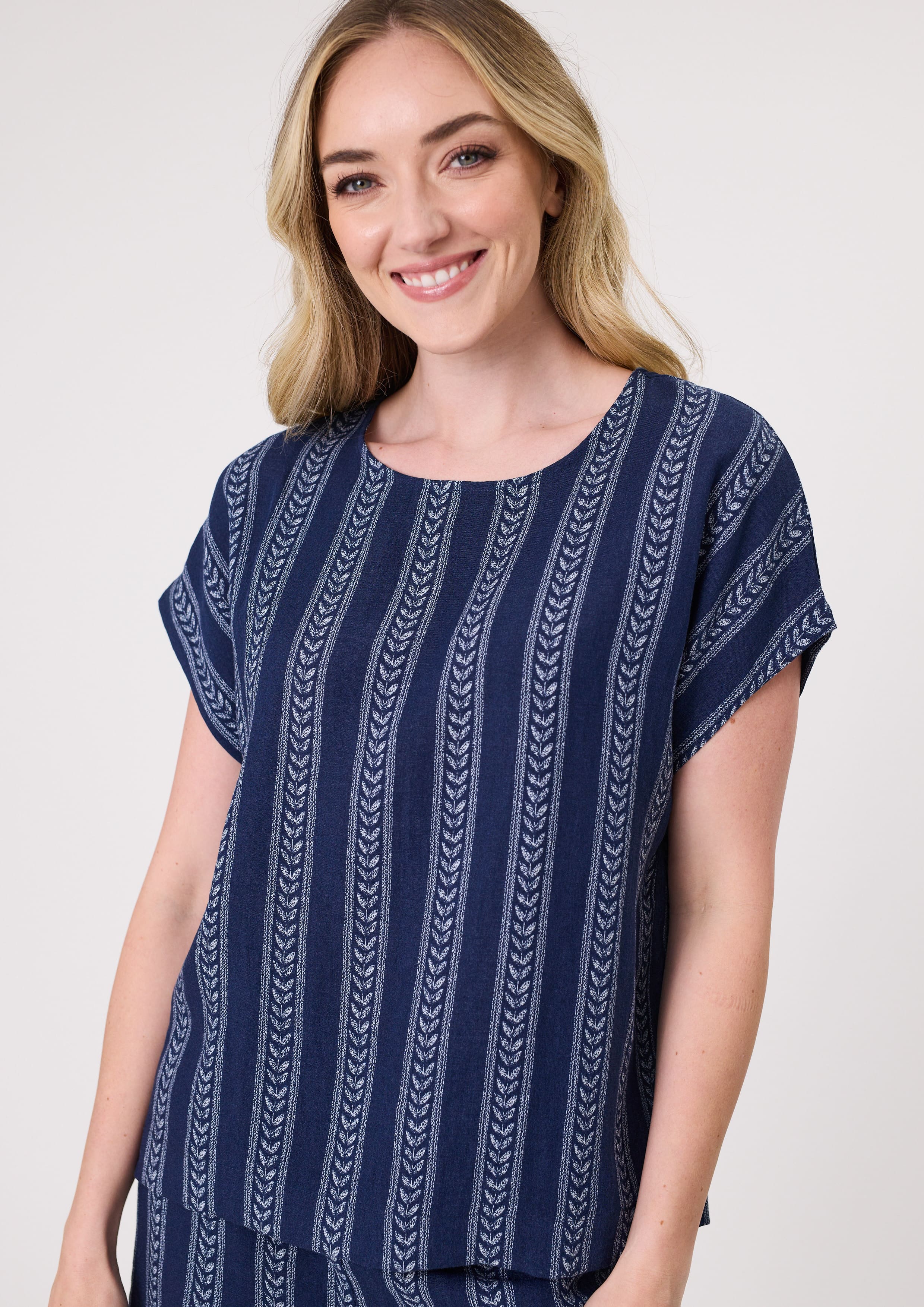 Melani Top in navy print with short sleeves and a relaxed fit, made from 100% viscose for a soft, breathable drape.