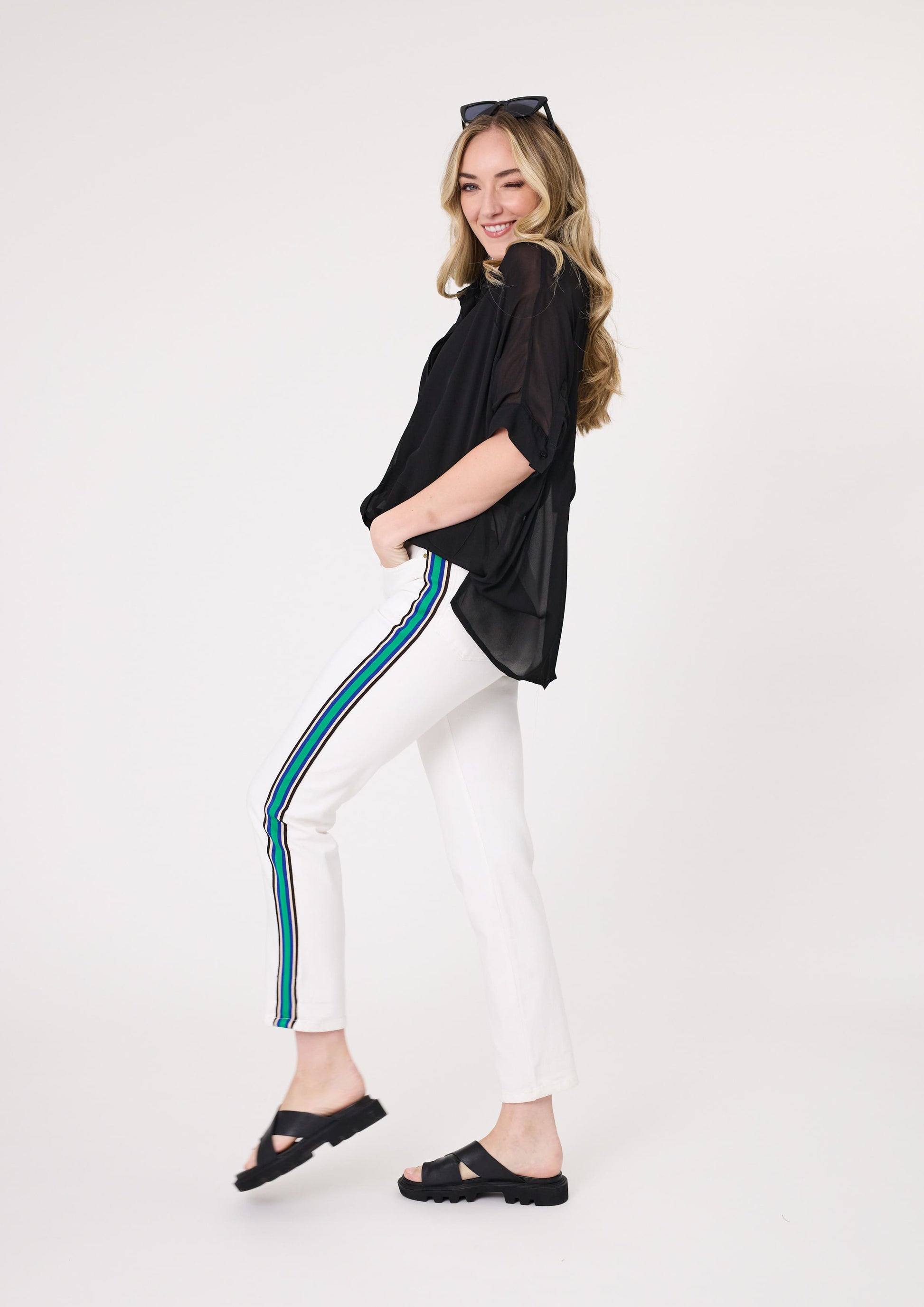 Terissa Jean in off-white with bold side stripe tape in green, blue, white, and black, featuring a slim fit and ankle-length cut in a stretchy cotton blend.