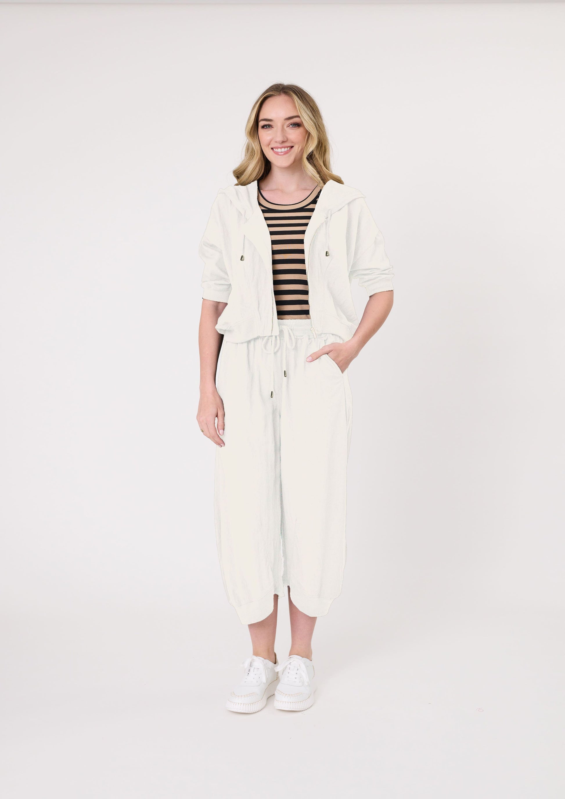 Bria Jacket in antique white with a cropped silhouette, hood, front zip closure, and functional pockets, made from a soft and flexible viscose-nylon blend.
