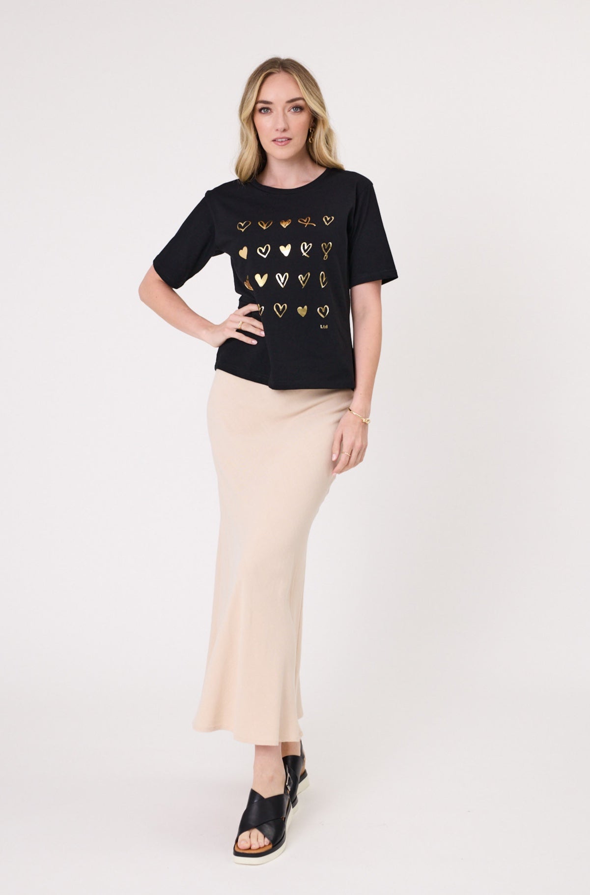 Carina Top in black with gold foil heart detailing, featuring a classic round neckline and short sleeves.
