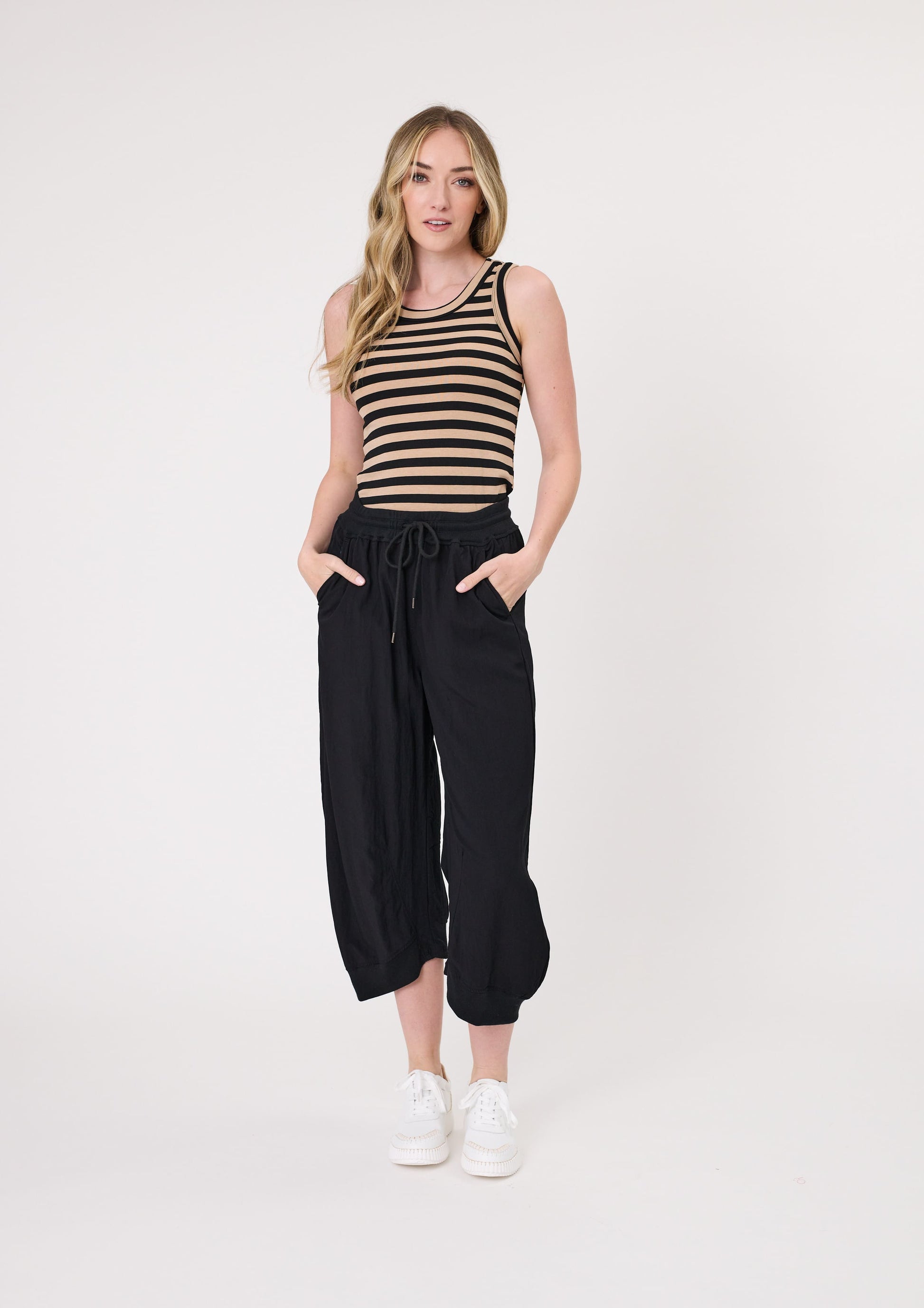 Eva Tank Top in mocha and black stripe with a sleek, ribbed texture, slim fit, and sleeveless design, made from a stretchy cotton blend for comfort.