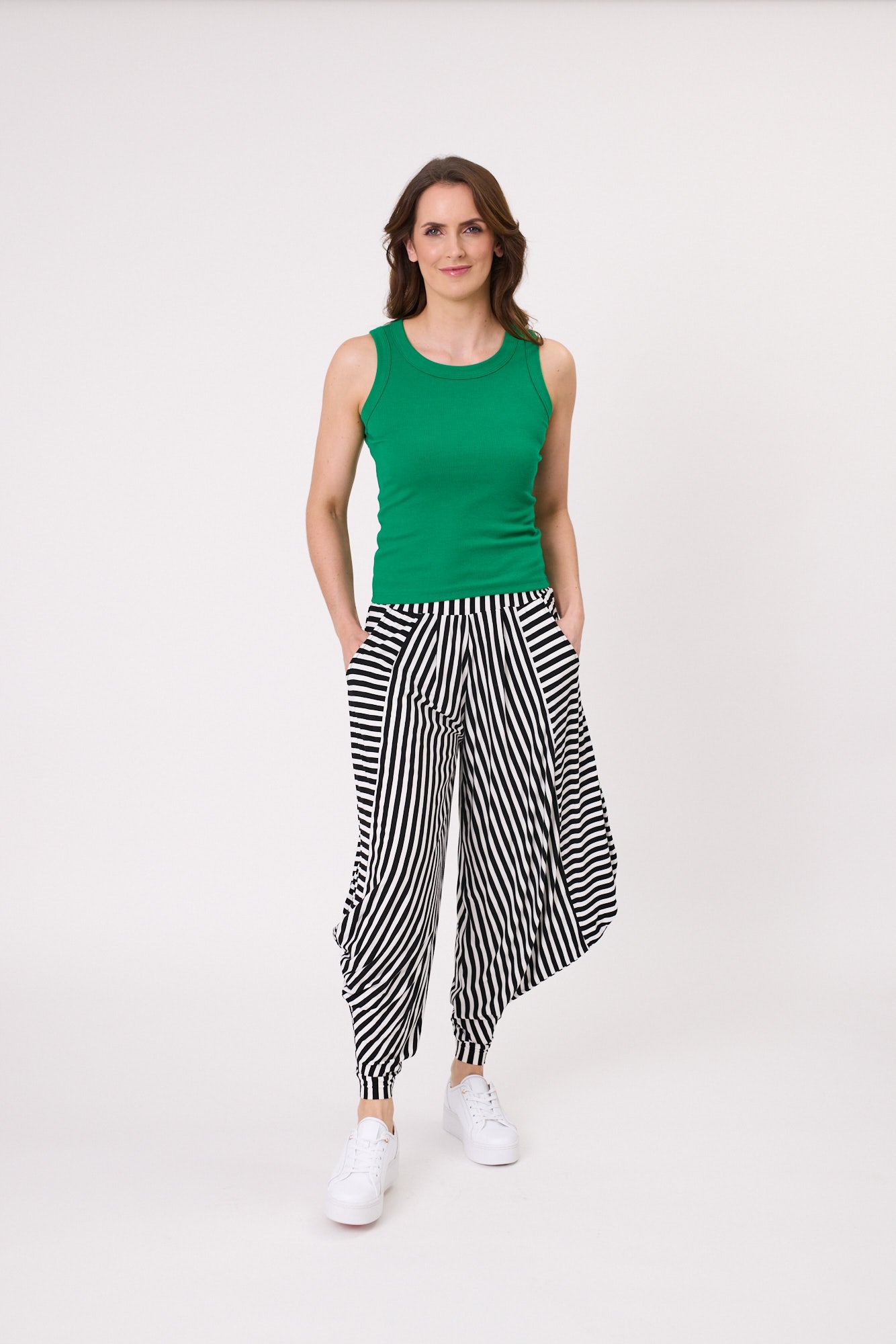 Eva Tank in green with a sleek, ribbed texture, slim fit, and sleeveless design, made from a stretchy cotton blend for comfort.