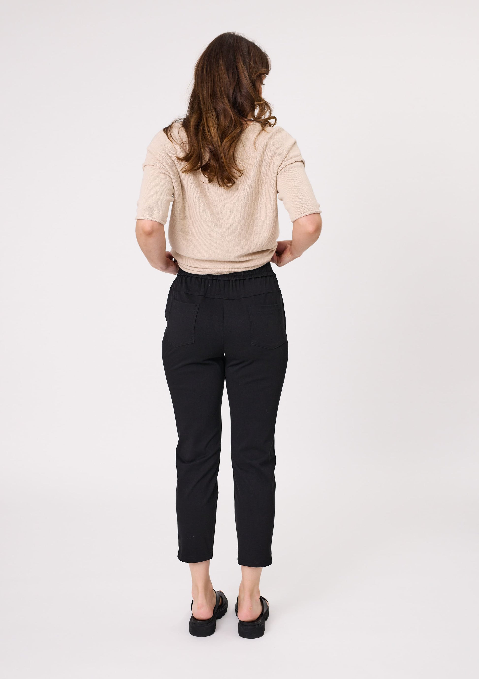 Back view of Gemma Pant in black showing elasticated waistband and two functional back pockets.