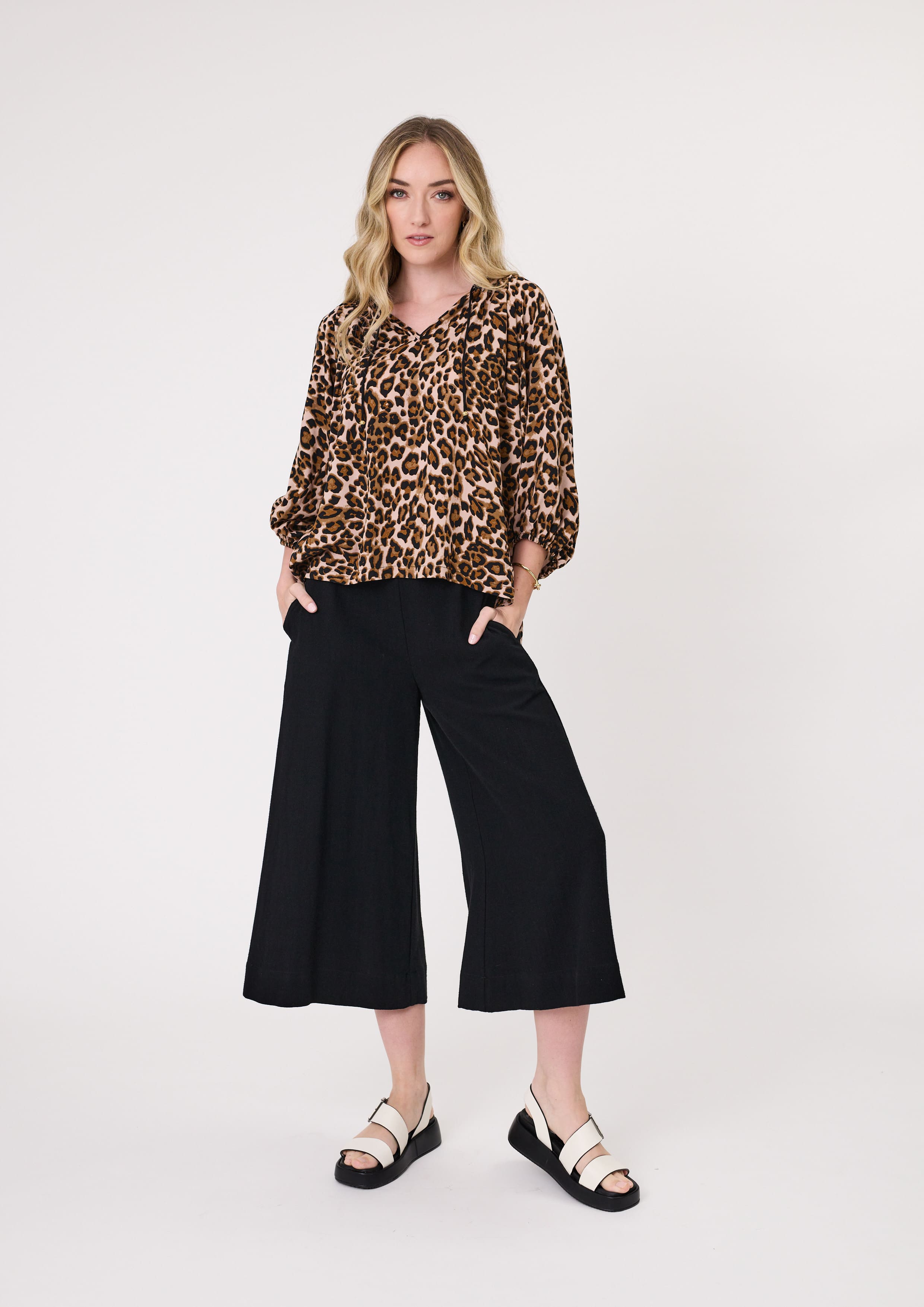 Gianna Top in leopard print, V-neckline, decorative tie strings, and three-quarter sleeves with subtle cuffing, made from 100% viscose for lightweight comfort.
