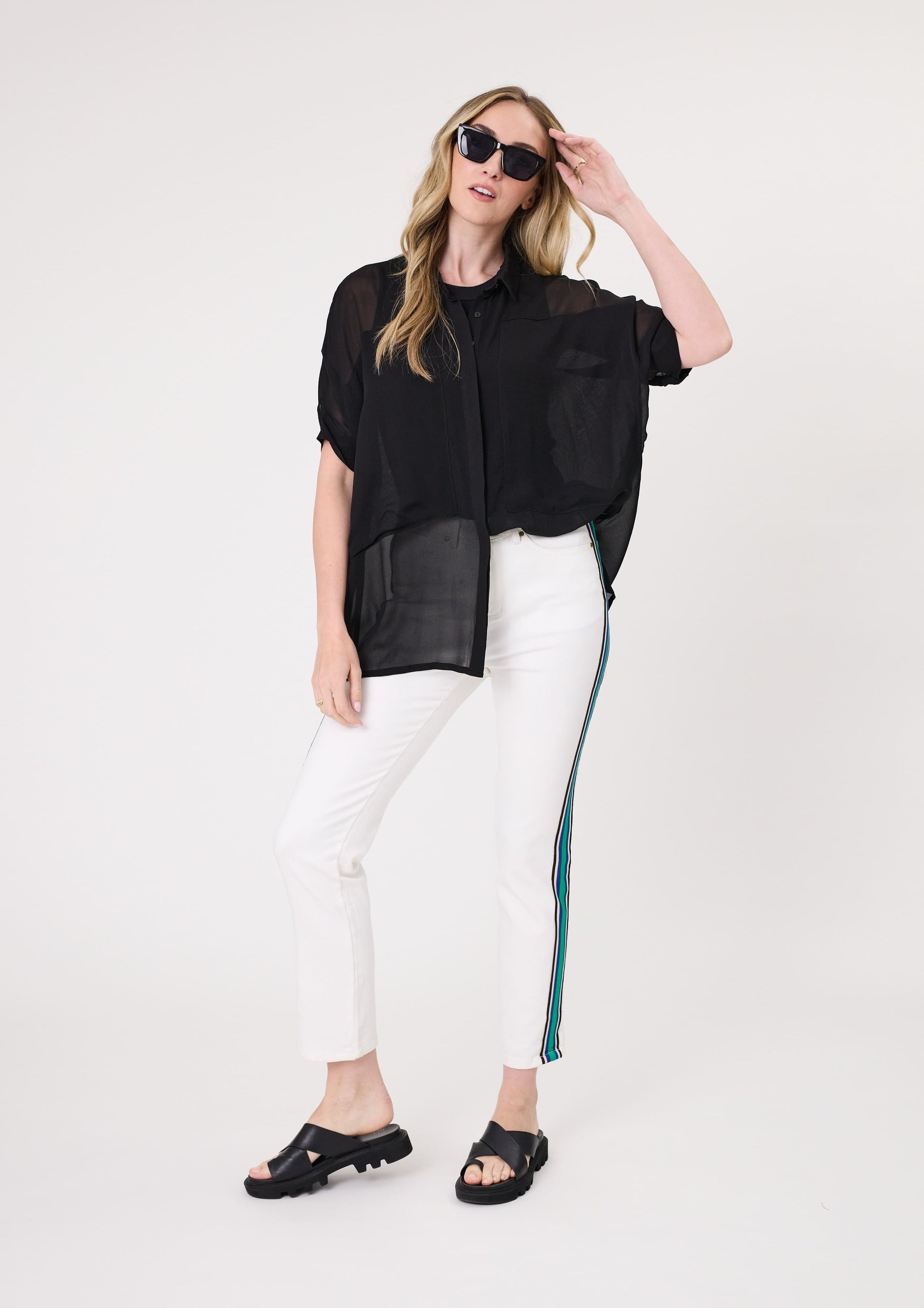 Sheer short-sleeve blouse in black with front buttons and a high-low hemline.