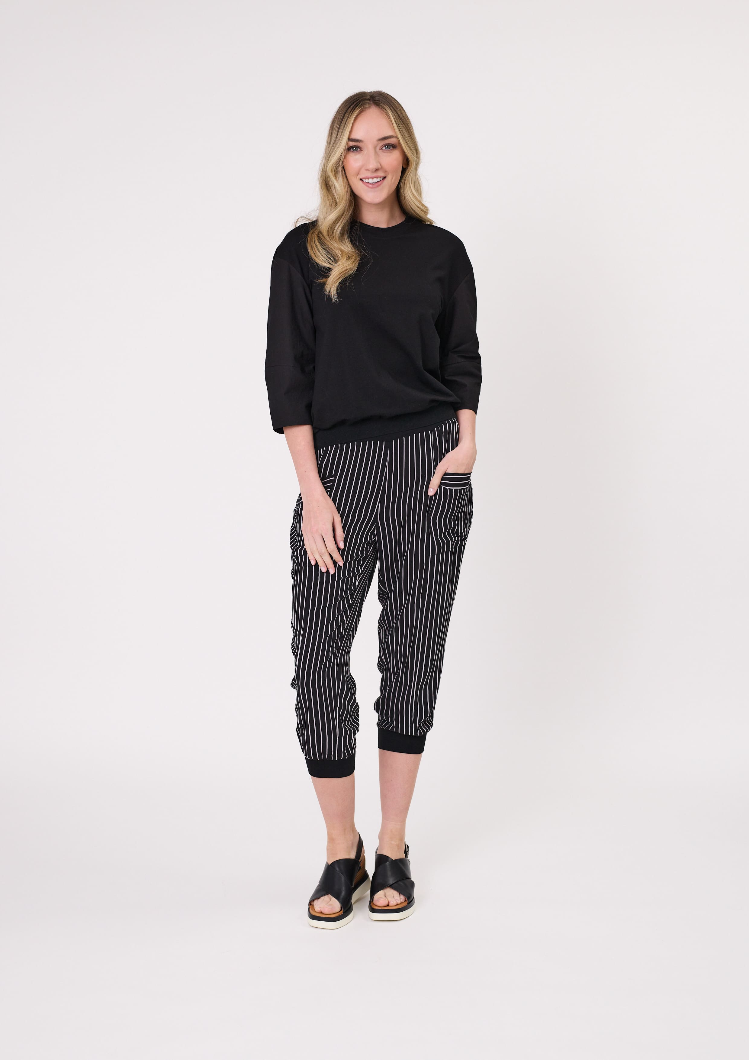 Harem Pant in black and white stripe, with a loose fit, cropped length, and side pockets, made from a lightweight, breathable viscose blend.