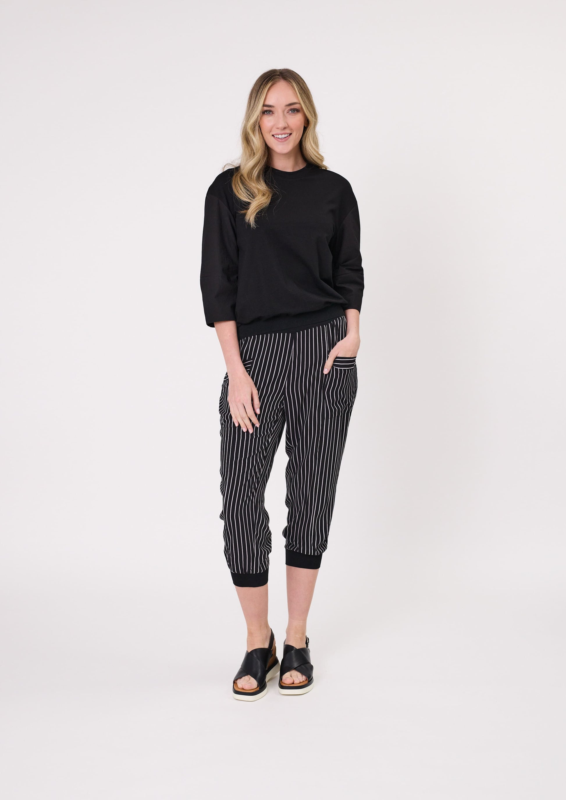 Harem Pant in black and white stripe, with a loose fit, cropped length, and side pockets, made from a lightweight, breathable viscose blend.