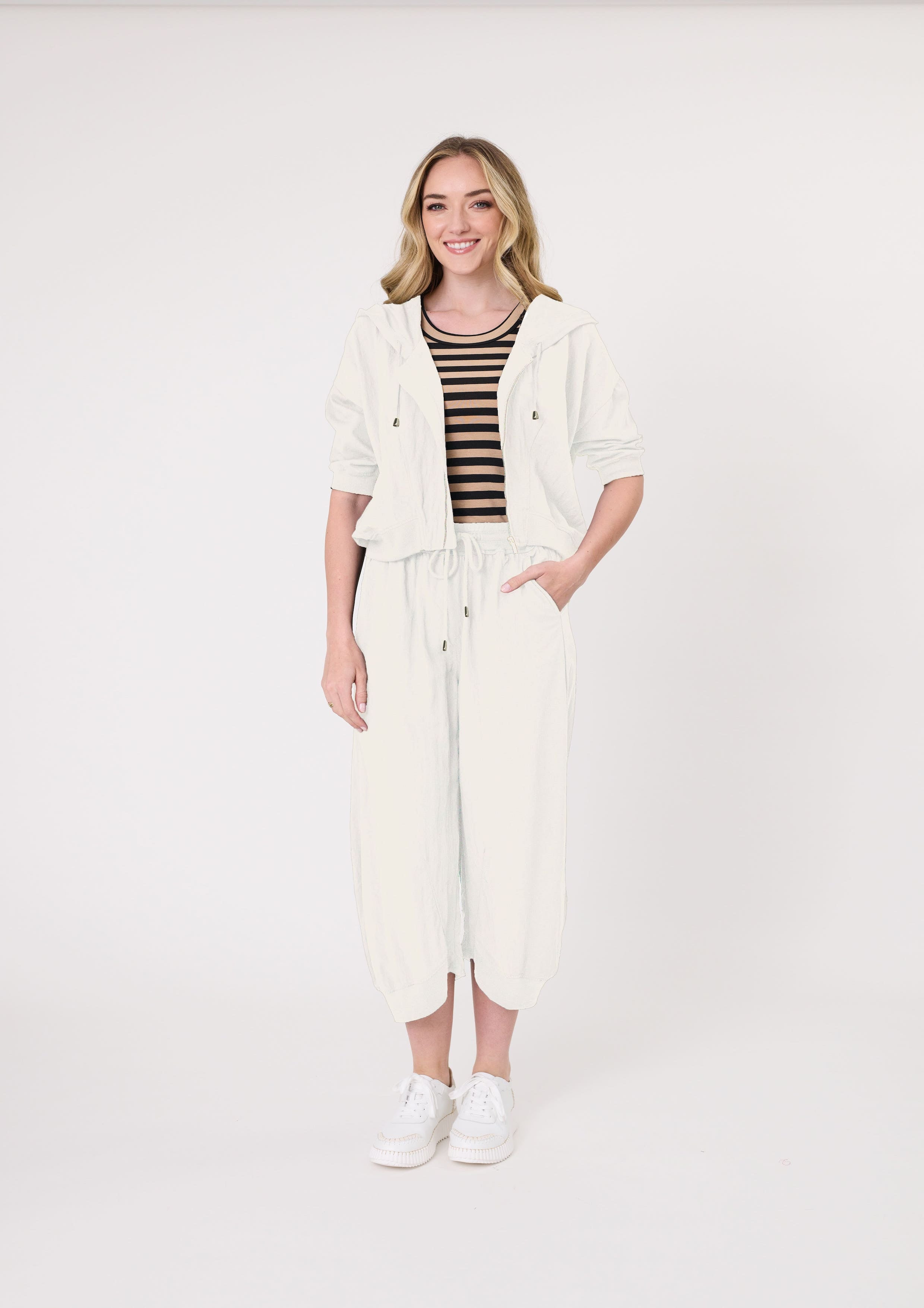 Larissa Pant in antique white with a relaxed, loose fit and three-quarter length, featuring a drawstring waistband and side pockets, made from a soft, breathable viscose-nylon blend.