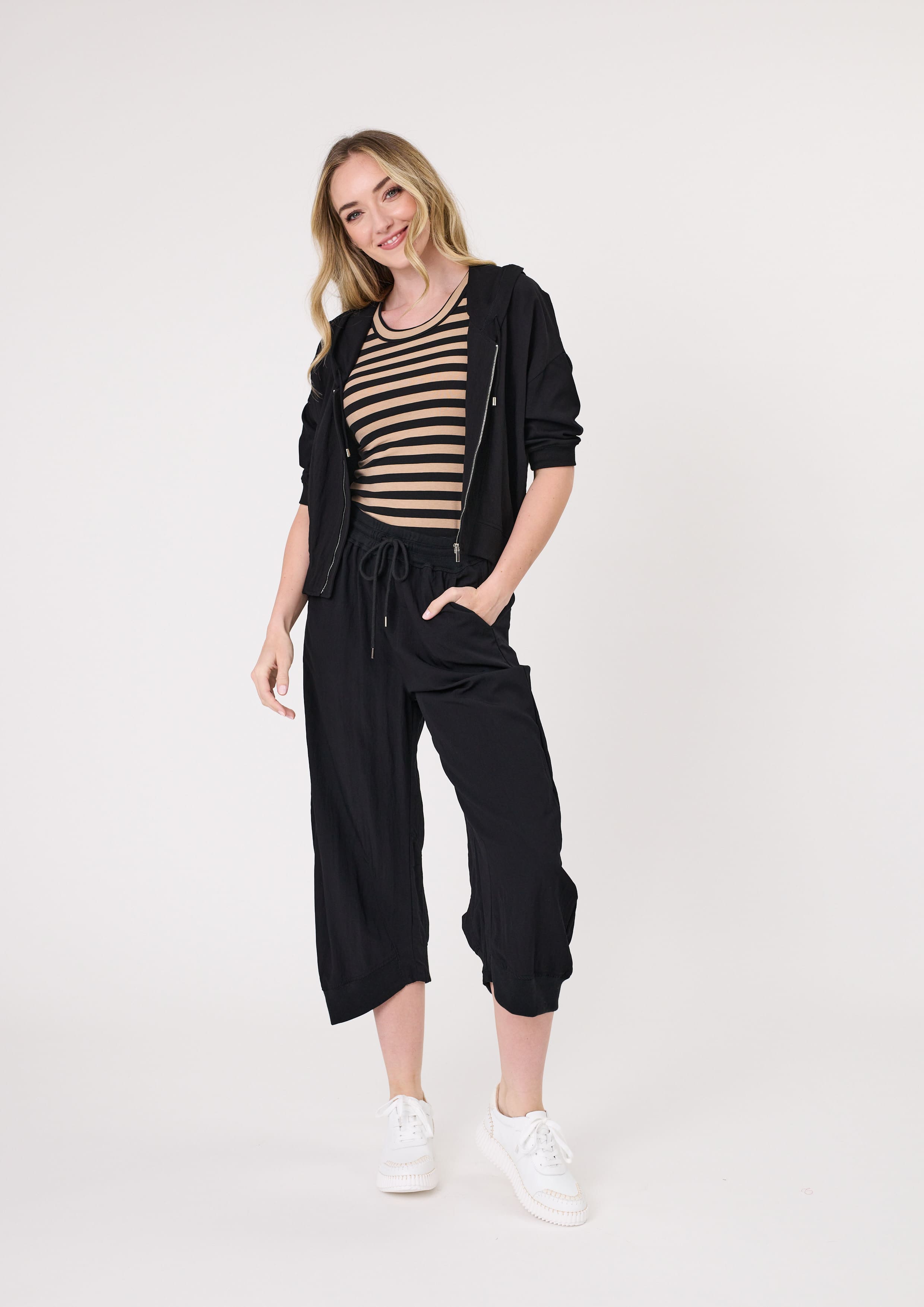 Larissa Pant in black with a relaxed, loose fit and three-quarter length, featuring a drawstring waistband and side pockets, made from a soft, breathable viscose-nylon blend.