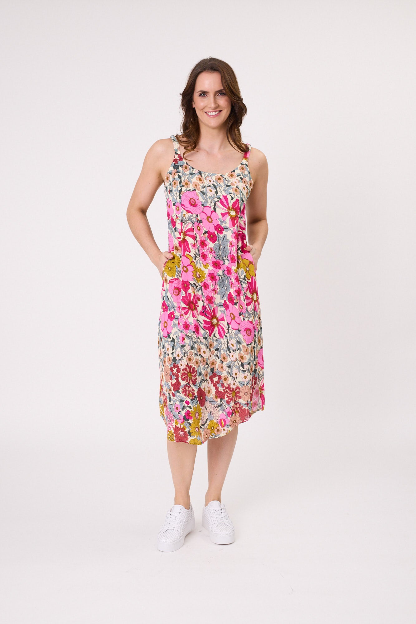 Maddie Dress in garden-inspired floral print with adjustable straps and a below-the-knee length for a soft, romantic silhouette.
