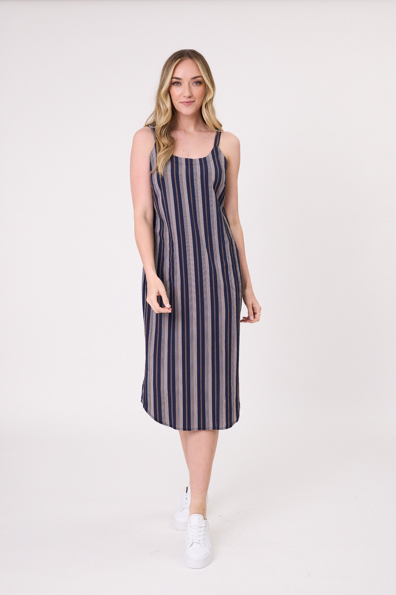 Maddie Dress in navy and white stripe with adjustable straps and a relaxed fit, falling just below the knee for an easy, summery look.