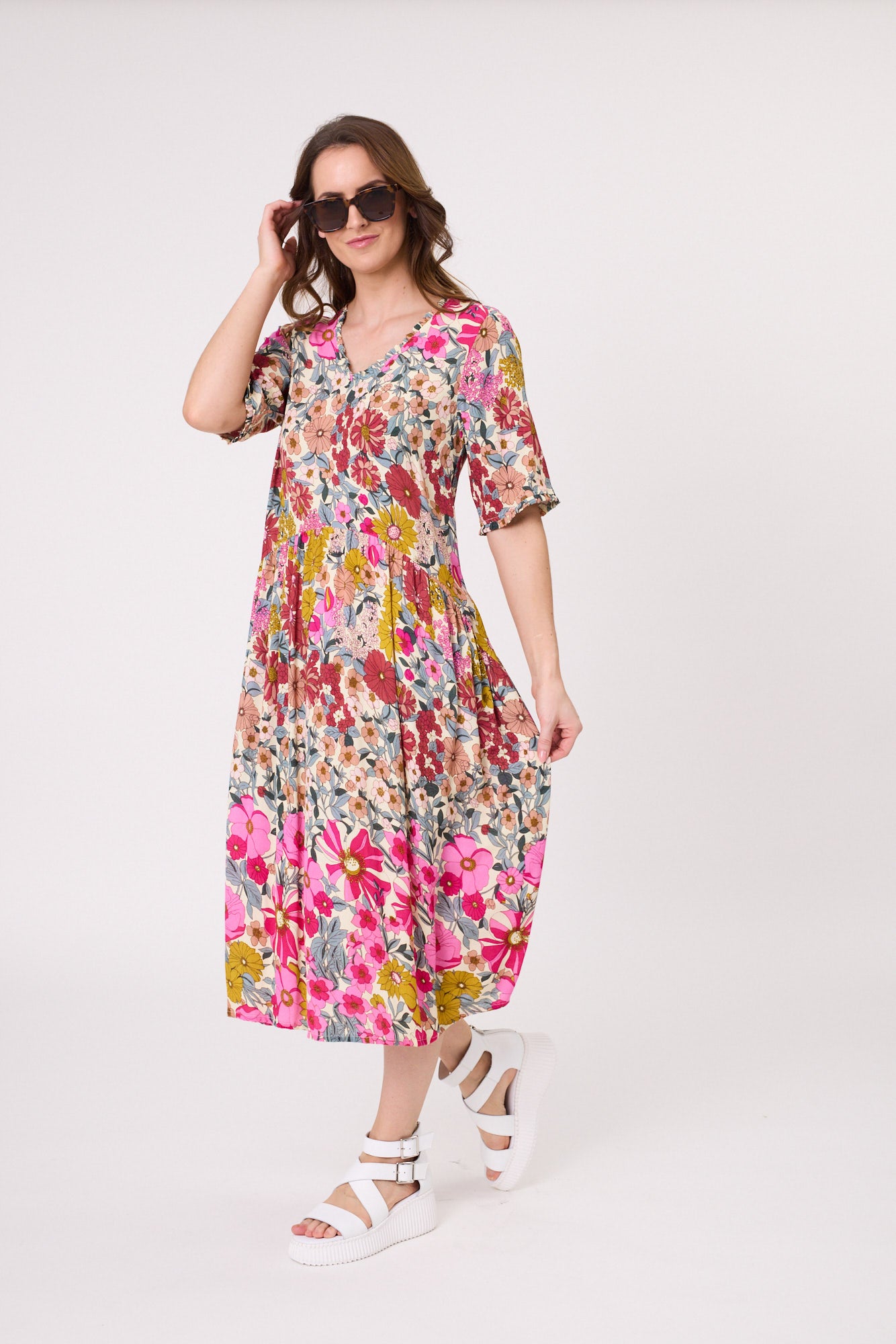 Marissa Dress with garden print, featuring a V-neckline, short sleeves, midi-length silhouette, and functional side pockets, made from a soft, breathable rayon-viscose blend.