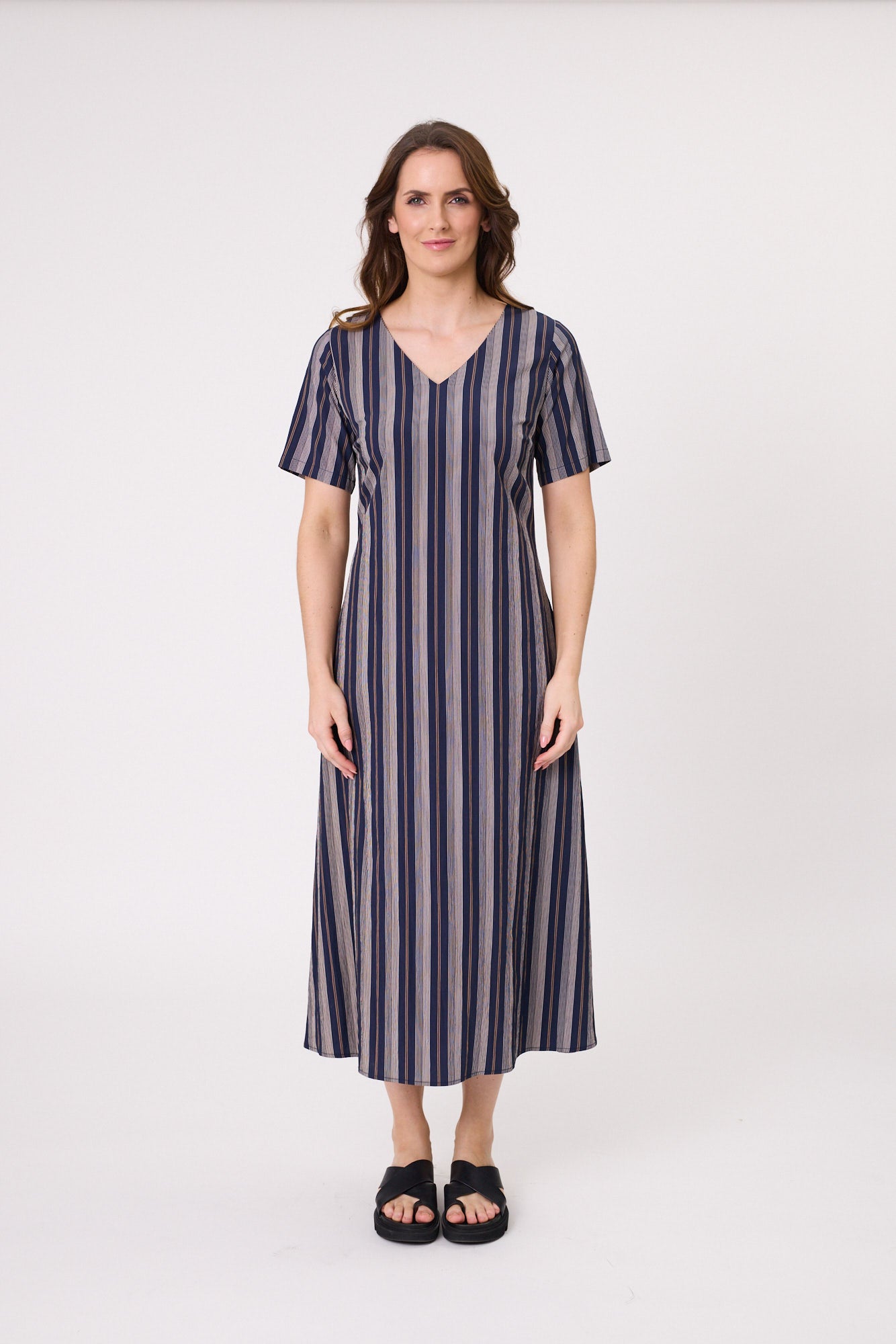 Marta Dress in classic navy stripe with a V-neckline, sleeves, pockets, and a flattering midi length, made from a soft, breathable viscose-nylon blend.