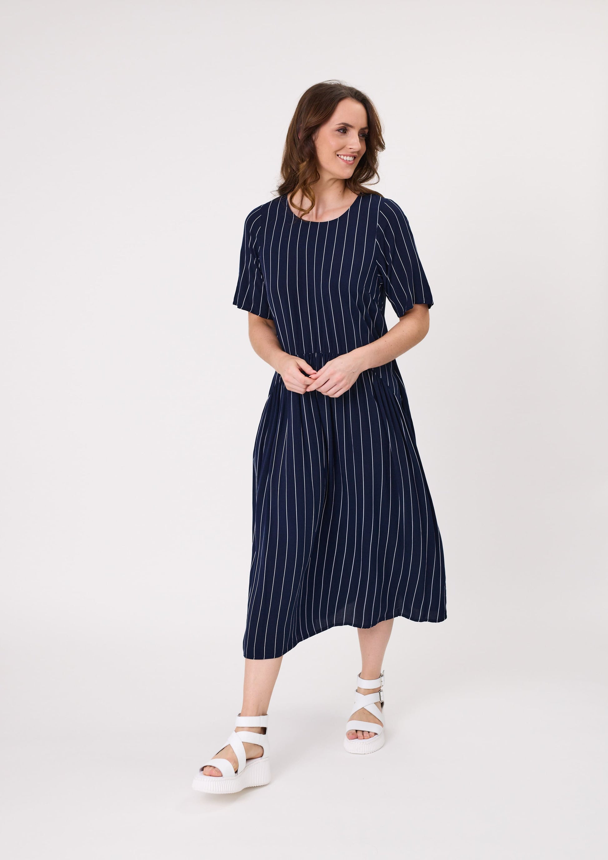 Monroe Dress in navy stripe with a relaxed fit, curved waistband, hidden pockets, and midi length, made from a soft viscose blend.