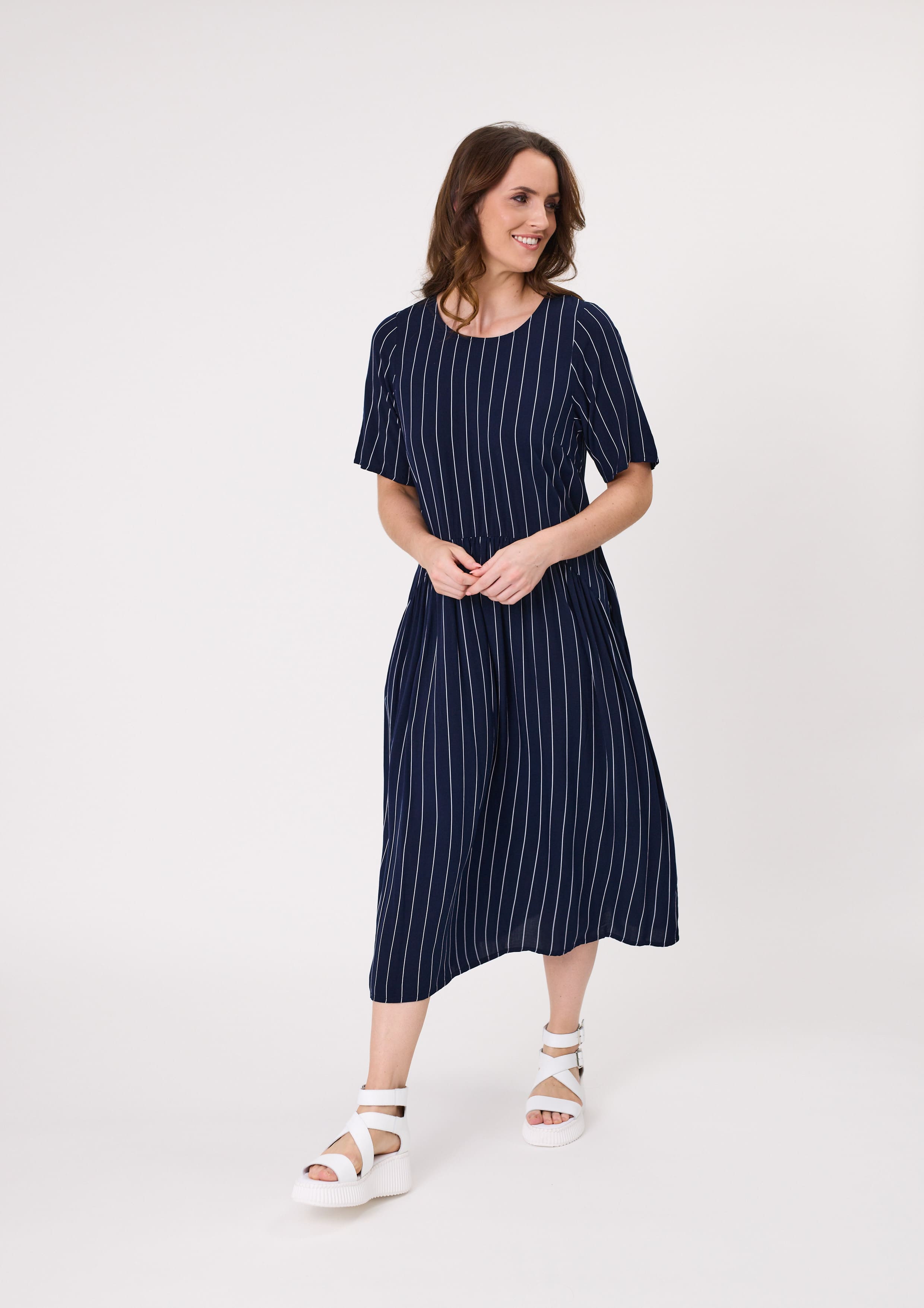 Monroe Dress in navy stripe with a relaxed fit, curved waistband, hidden pockets, and midi length, made from a soft viscose blend.