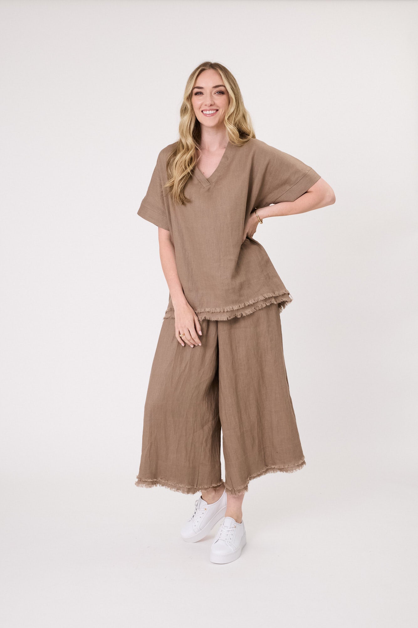 Nicole Linen Pant in mocha with a loose fit, side pockets, frayed hem, and three-quarter length.