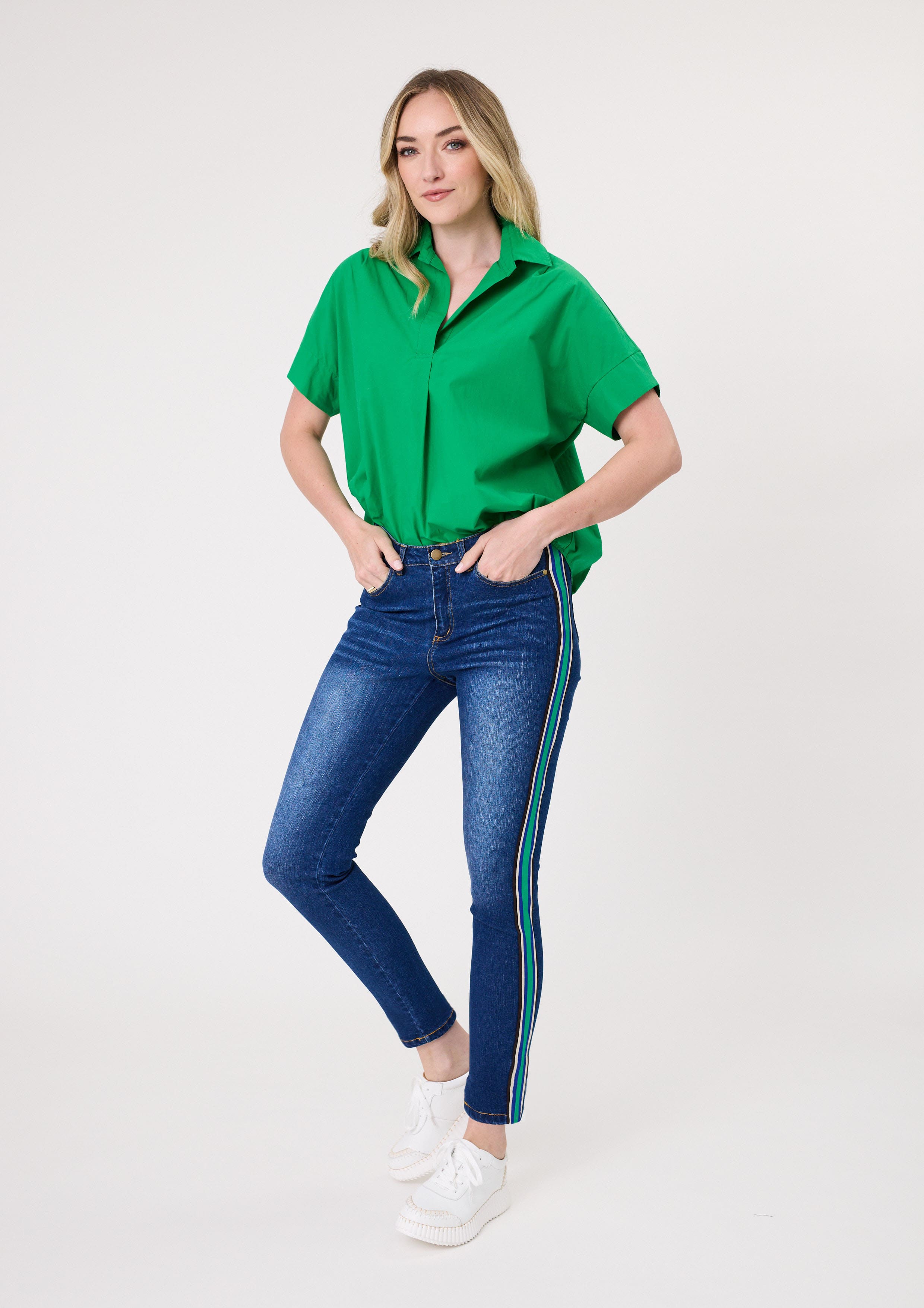 Terissa Jean in denim with bold side stripe tape in green, blue, white, and black, featuring a slim fit and ankle-length cut in a stretchy cotton blend.